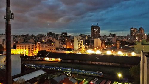 Illuminated cityscape against sky at night