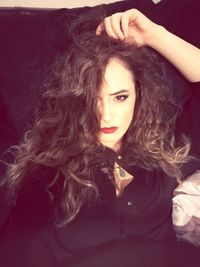 Close-up of young woman against gray background