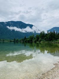 Scenic view of lake and mountains against sky