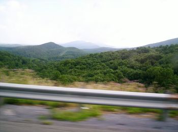 Narrow road along countryside landscape