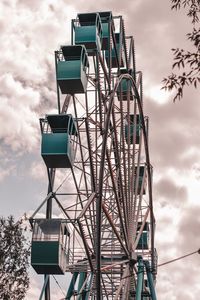 Low angle view of ferris wheel against sky