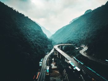 High angle view of road amidst mountains against sky