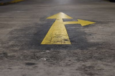 High angle view of yellow arrows on road