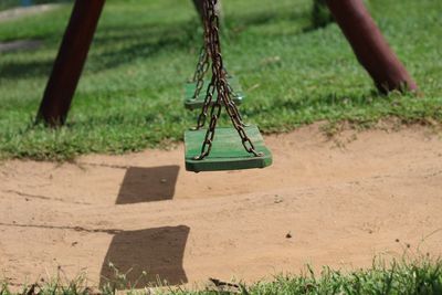 Empty swings hanging in playground