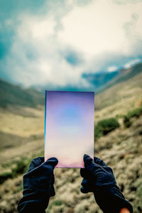 Low section of woman standing on field against sky