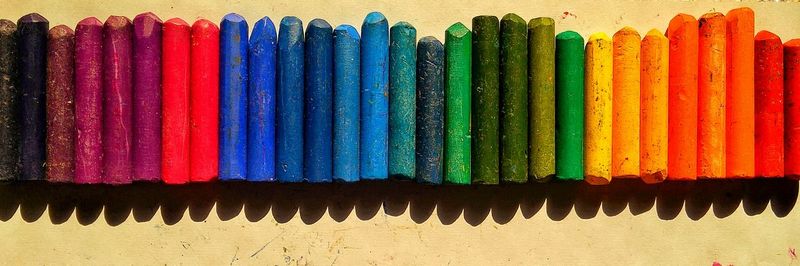 Panoramic shot of colorful crayons on table