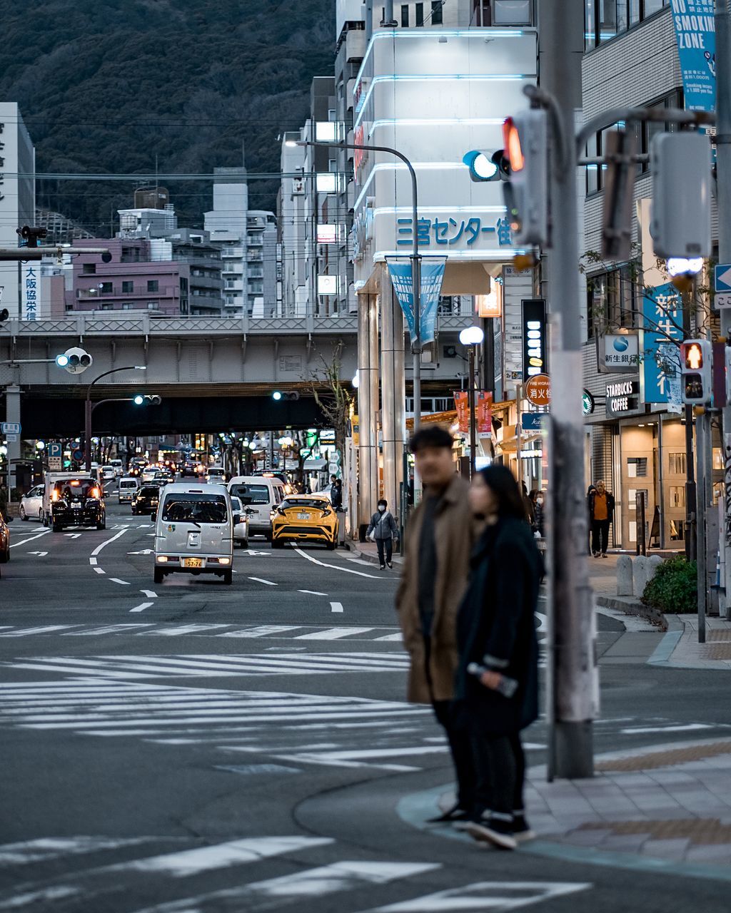 city, architecture, transportation, car, motor vehicle, street, mode of transportation, building exterior, built structure, city life, land vehicle, walking, real people, road, one person, city street, lifestyles, rear view, adult, light