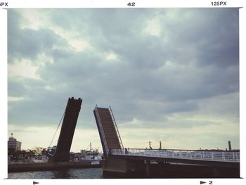 Buildings against cloudy sky