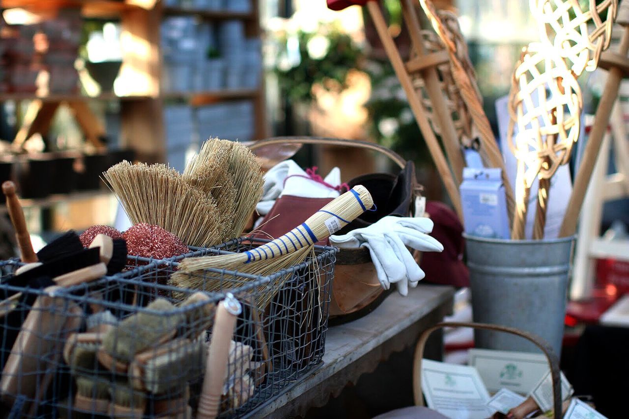 focus on foreground, indoors, retail, basket, chair, day, table, market, close-up, still life, food, for sale, selective focus, no people, sunlight, hanging, animal representation, food and drink, incidental people