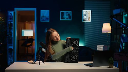 Young woman using mobile phone while sitting at restaurant