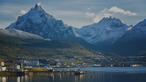 Scenic view of lake by mountain against sky