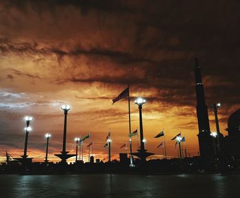 Illuminated commercial dock against sky at night