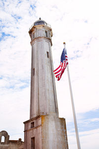 Low angle view of flag on tower against sky