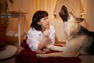 Young woman with dog at home