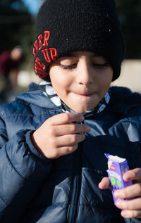 Portrait of boy eating candy