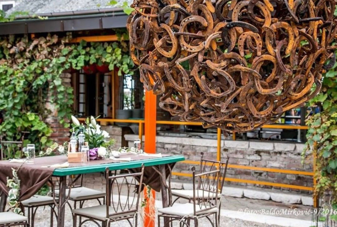 CHAIRS AND TABLE AT RESTAURANT BY BUILDING