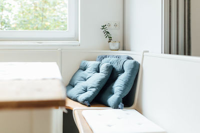 Empty chair on bed at home