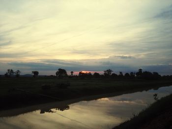 Scenic view of lake against sky during sunset