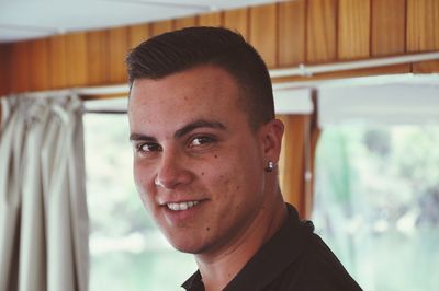 Portrait of smiling young man at home