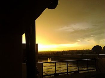 Silhouette of built structure against sky at sunset