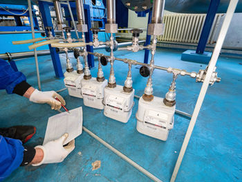 Low section of man holding machine