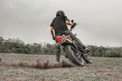 Man riding motorcycle on field