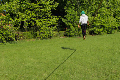 Full length of person slacklining on tightrope in park