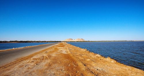 Scenic view of sea against clear blue sky