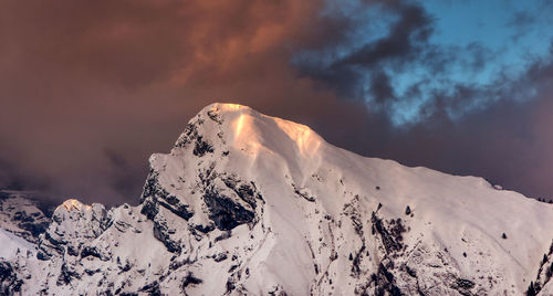 Scenic view of snowcapped mountain against sky during sunset