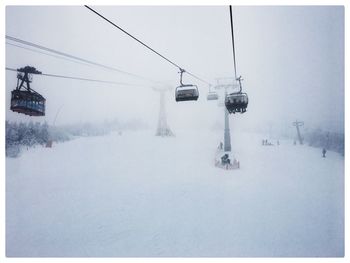 Overhead cable car covered with snow