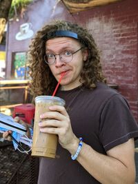 Portrait of young woman drinking water