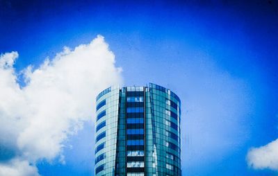 Low angle view of modern building against blue sky