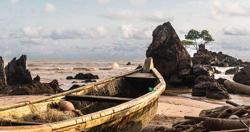 Panoramic view of rocks on beach against sky