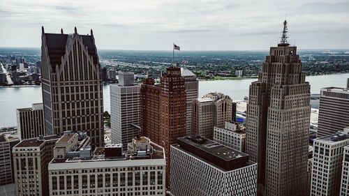 Aerial view of city against cloudy sky