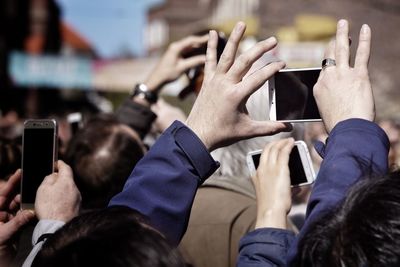 People photographing with mobile phone outdoors