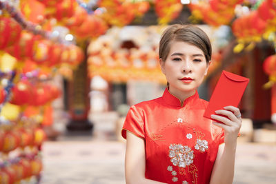 Portrait of a beautiful young woman standing outdoors