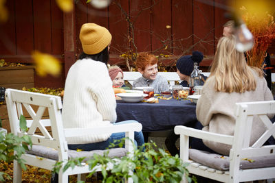 Family and friends sitting at table for social gathering