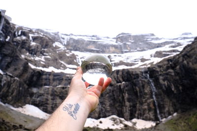 Midsection of person holding rock