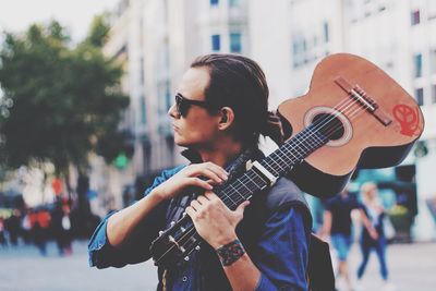 Portrait of young man holding camera