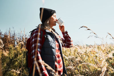 Woman taking break and enjoying the coffee during vacation trip. spending vacation close to nature