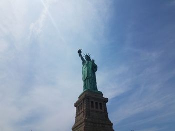 Low angle view of statue against cloudy sky