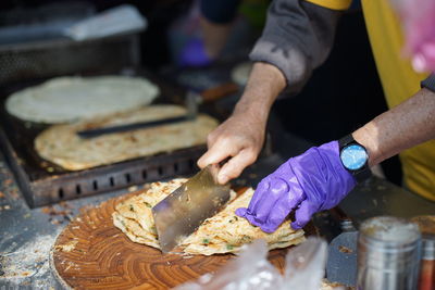 Cropped image of person preparing food