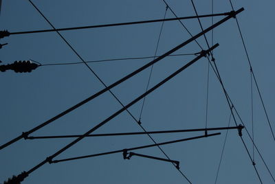 Low angle view of cables against clear blue sky