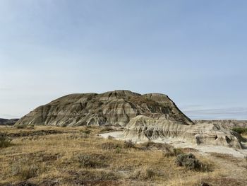 Rock formations on landscape against sky