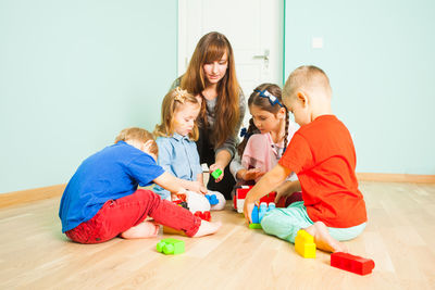 Friends and son on floor at home