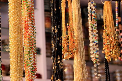 Close-up of multi colored jewelry for sale at market stall