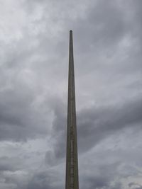 Low angle view of tower against cloudy sky