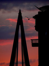 Low angle view of silhouette building against sky during sunset