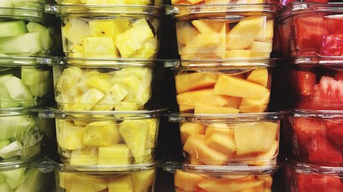 Full frame shot of various chopped fruits in containers