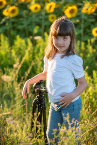 Portrait of girl standing on field